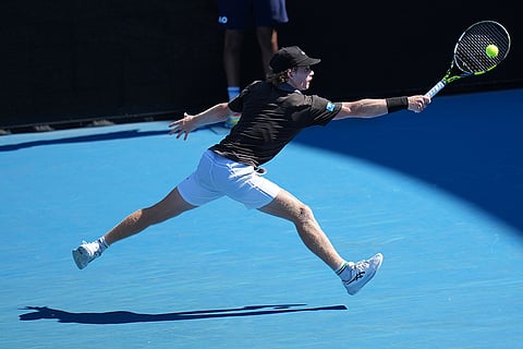 Dane Sweeny of Australia plays a backhand return to Gael Monfils of France during their first round match at the Australian Open tennis championship in Melbourne, Australia.