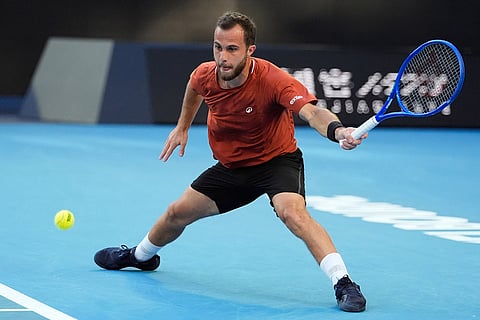 Hugo Gaston of France plays a forehand return to Jannik Sinner of Italy during their first round match at the Australian Open tennis championship in Melbourne, Australia.