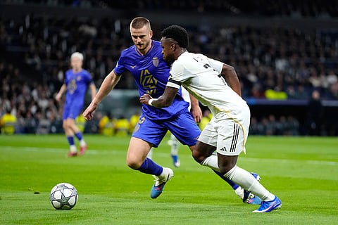 Monaco's Eric Dier fights for the ball against Real Madrid's Vinicius Junior during the Champions League opening phase soccer match between Real Madrid and Monaco in Madrid.