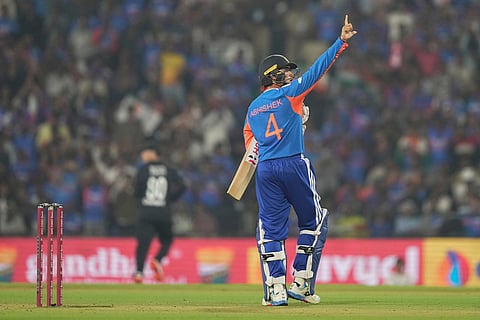 India's Abhishek Sharma celebrates after scoring fifty runs during the first T20 cricket match between India and New Zealand in Nagpur, India.