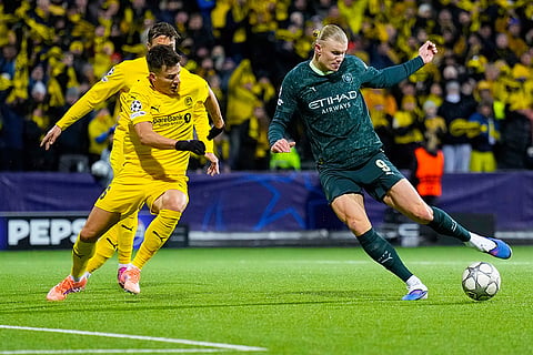 Manchester City's Erling Haaland, right, and Glimt's Jostein Gundersen battle for the ball during the Champions League soccer match between Bodo/Glimt and Manchester City in Bodo, Norway.