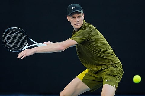 Jannik Sinner of Italy plays a forehand return to Hugo Gaston of France during their first round match at the Australian Open tennis championship in Melbourne, Australia.