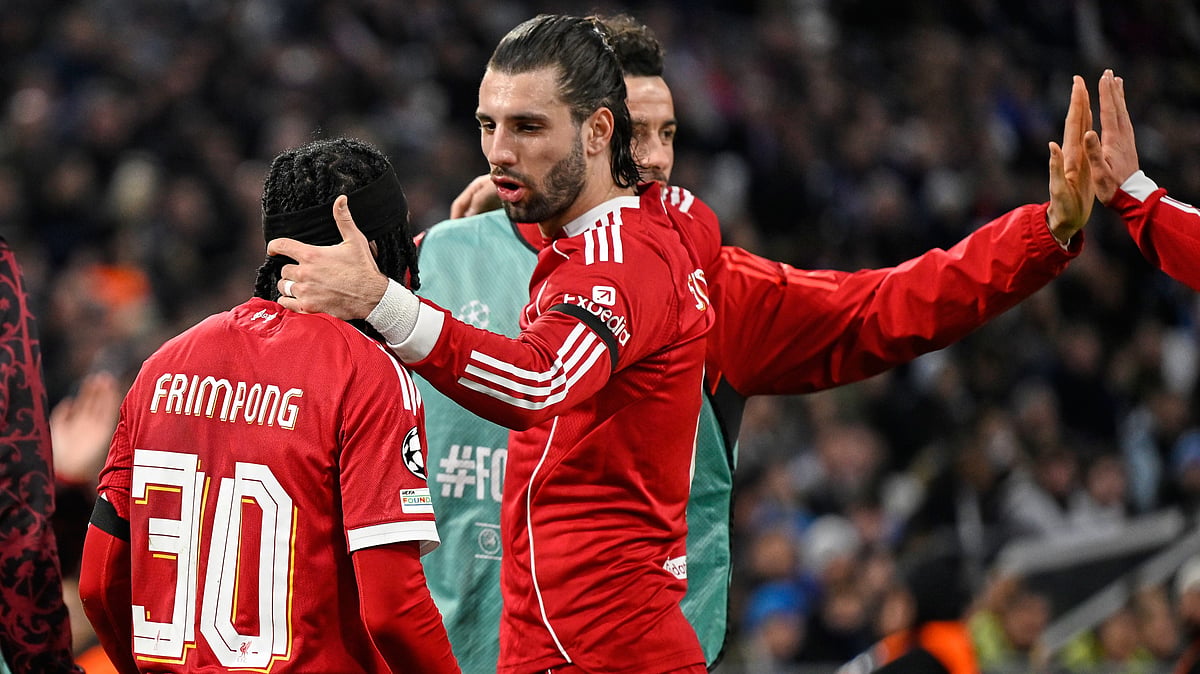 | Photo: AP/Philippe Magoni : Liverpool's Jeremie Frimpong Dominik Szoboszlai celebrate after Marseille's goalkeeper Geronimo Rulli scored an own goal during the Champions League opening phase match on Wednesday, January 21, 2026.