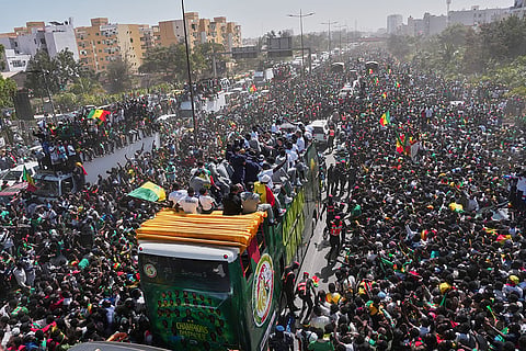 The Senegalese soccer team rides through thousands of cheering fans celebrating their victory in the Africa Cup of Nations soccer tournament, in Dakar, Senegal.