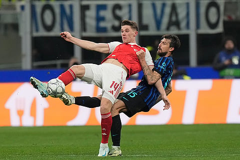 Arsenal's Viktor Gyoekeres, left, challenges for the ball with Inter Milan's Francesco Acerbi during the Champions League opening phase soccer match between Inter Milan and Arsenal in Milan, Italy.