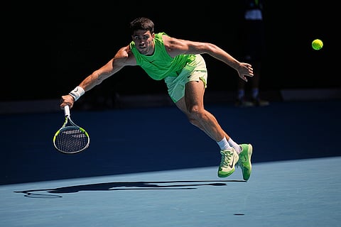 Carlos Alcaraz of Spain plays a forehand return to Yannick Hanfmann of Germany during their second round match at the Australian Open tennis championship in Melbourne, Australia.