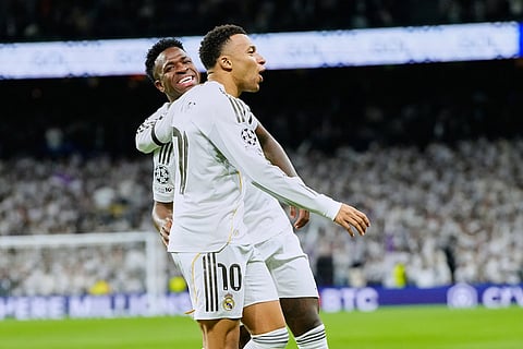 Real Madrid's Kylian Mbappe celebrates with Vinicius Junior the opening goal during the Champions League opening phase soccer match between Real Madrid and Monaco in Madrid.