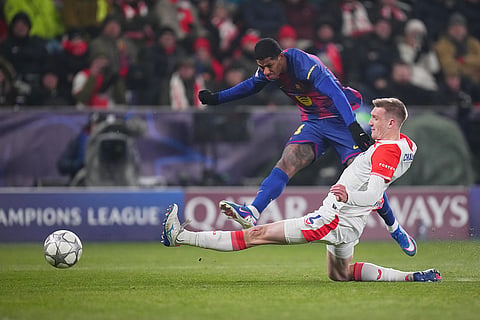 Barcelona's Marcus Rashford, top, attempts a shot at goal in front of Slavia's Stepan Chaloupek during the Champions League opening phase soccer match between Slavia Prague and Barcelona in Prague, Czech Republic.