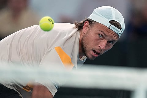 Alexandre Muller of France plays a backhand return to Alexander Zverev of Germany during their second round match at the Australian Open tennis championship in Melbourne, Australia.