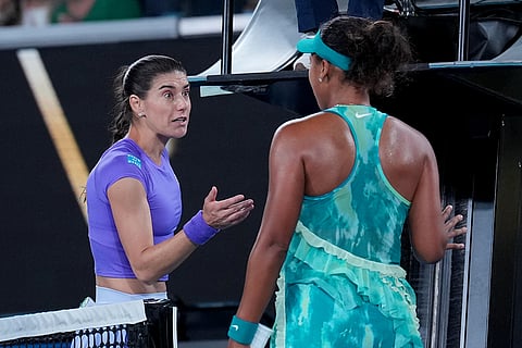 Naomi Osaka, right, of Japan talks with Sorana Cirstea, left, of Romania following their second round match at the Australian Open tennis championship in Melbourne, Australia.
