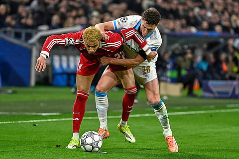 Marseille's Hamed Traore, right, challenges for the ball with Liverpool's Hugo Ekitike during the Champions League opening phase soccer match between Marseille and Liverpool in Marseille, France.