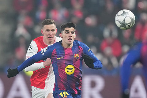 Barcelona's Gerard Martin eyes the ball during the Champions League opening phase soccer match between Slavia Prague and Barcelona in Prague, Czech Republic.