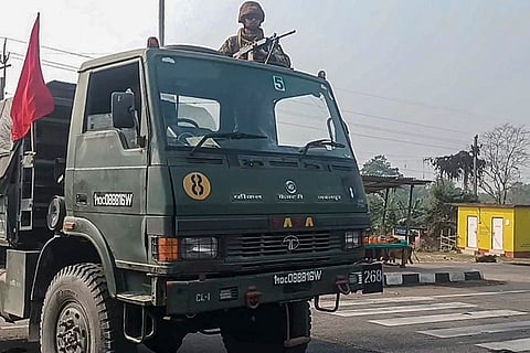 Army personnel conduct a flag march after deployment in sensitive areas, where two persons were killed in mob violence, leading to arson and clashes allegedly between the Bodos and Adivasis, in Assam’s Kokrajhar district.