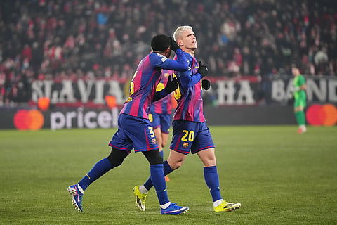 Barcelona's Dani Olmo, right, celebrates after scoring his side's third goal during the Champions League opening phase soccer match between Slavia Prague and Barcelona in Prague, Czech Republic.