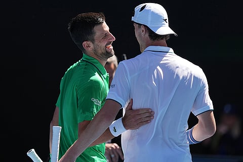 Novak Djokovic, left, of Serbia is congratulated by Francesco Maestrelli of Italy following their second round match at the Australian Open tennis championship in Melbourne, Australia.