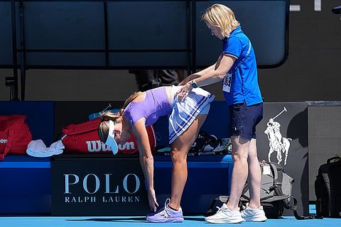 McCartney Kessler of the U.S. receives treatment from a trainer during her second round match against compatriot Jessica Pegula at the Australian Open tennis championship in Melbourne, Australia.