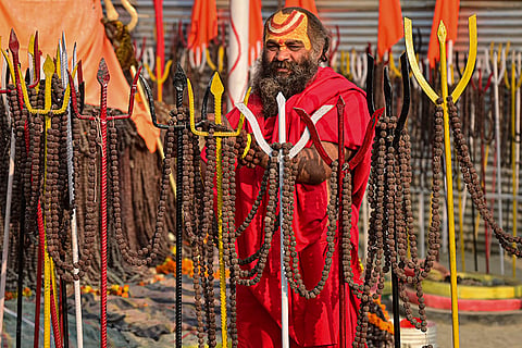 A holy man performs rituals on the eve of the ‘Basant Panchami’ festival during the ongoing ‘Magh Mela’ festival, at Sangam, in Prayagraj.