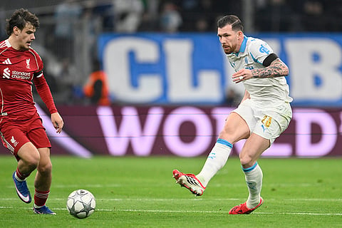 Marseille's Pierre-Emile Hojbjerg, right, kicks the ball during the Champions League opening phase soccer match between Marseille and Liverpool in Marseille, France.