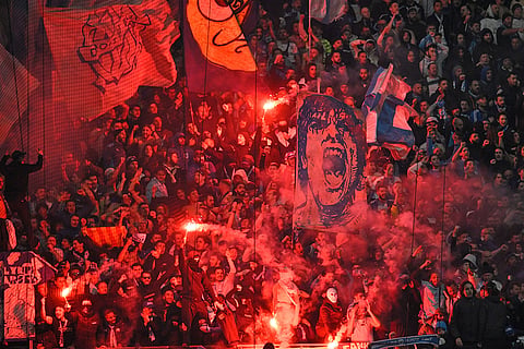 Fans burn flares and waves flags during the Champions League opening phase soccer match between Marseille and Liverpool in Marseille, France.
