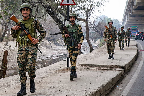 Border Security Force (BSF) personnel patrol the Jammu-Akhnoor-Poonch National Highway ahead of Republic Day, in Jammu.