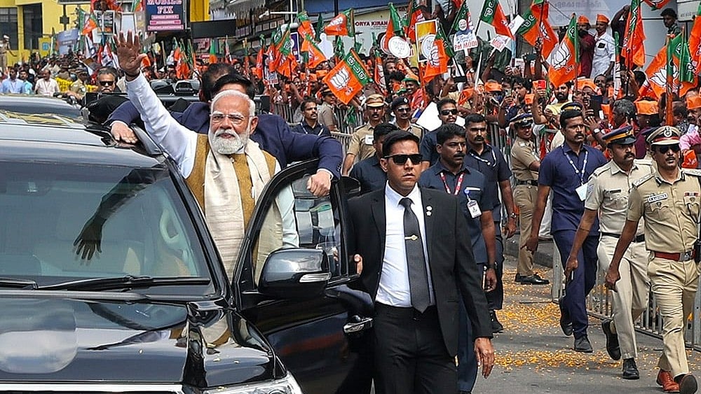 | Photo: PMO via PTI : In this image released on Jan. 23, 2026, Prime Minister Narendra Modi greets people during a roadshow upon his arrival, in Thiruvananthapuram.
