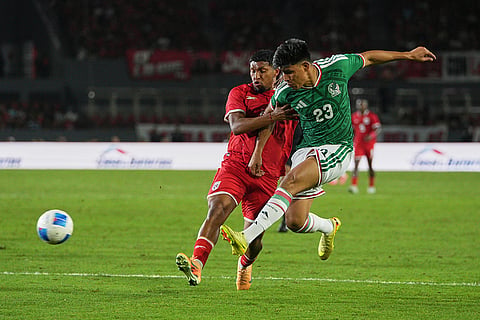 Mexico's Jesus Gallardo, right, shoots as Panama's Luis Asprilla defends during an international friendly soccer match in Panama City.