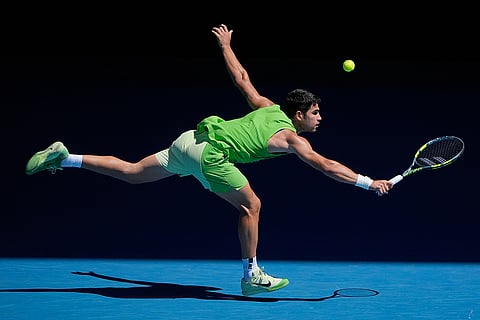 Carlos Alcaraz of Spain plays a backhand return to Corentin Moutet of France during their third round match at the Australian Open tennis championship in Melbourne, Australia.