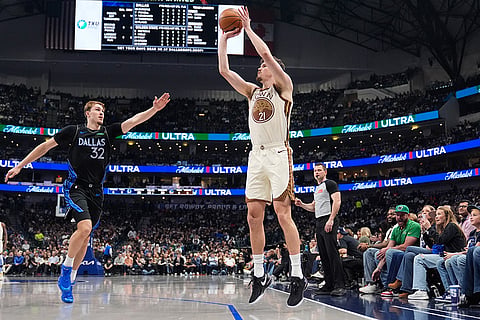 Golden State Warriors center Quinten Post (21) shoots as Dallas Mavericks' Cooper Flagg (32) defends in the first half of an NBA basketball game in Dallas.