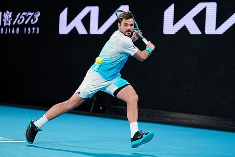Stan Wawrinka of Switzerland plays a backhand return to Taylor Fritz of the U.S. during their third round match at the Australian Open tennis championship in Melbourne, Australia.