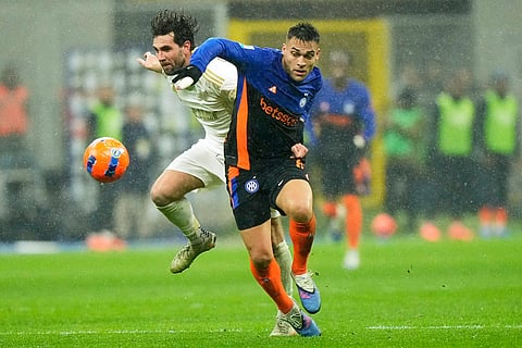 Inter Milan's Lautaro Martinez is challenged by Pisa's Arturo Calabresi, rear, during a Serie A soccer match between Inter Milan and Pisa, in Milan, Italy.