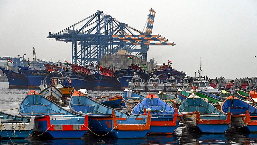 | Photo: PTI : Fishing boats remain anchored against the backdrop of Vizhinjam International Seaport in the wake of bad weather and the impact of cyclonic storm Ditwah, in Thiruvananthapuram.