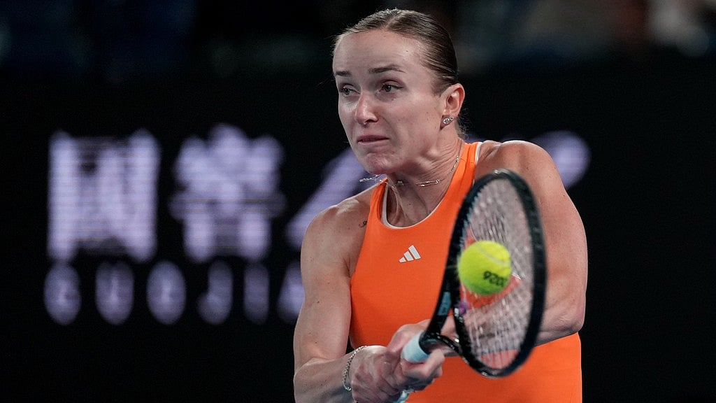 Photo: AP : Elina Svitolina of Ukraine plays a backhand return to Mirra Andreeva of Russia during their fourth round match at the Australian Open tennis championship in Melbourne.