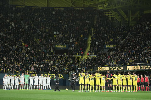 Real Madrid, left, and Villarreal players observe a moment of silence for those that lost their lives in the recent train crash in Spain before a Spanish La Liga soccer match between Villarreal and Real Madrid in Villarreal, Spain.