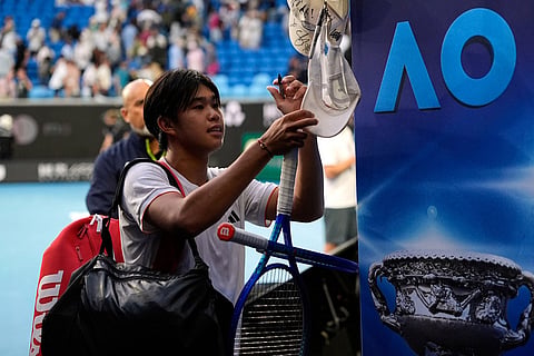 Learner Tien of the U.S. signs autographs after defeating Daniil Medvedev of Russia in their fourth round match at the Australian Open tennis championship in Melbourne, Australia.