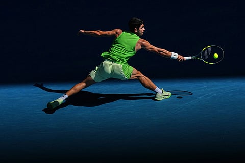 Carlos Alcaraz of Spain plays a backhand return to Tommy Paul of the U.S.during their fourth round match at the Australian Open tennis championship in Melbourne, Australia.