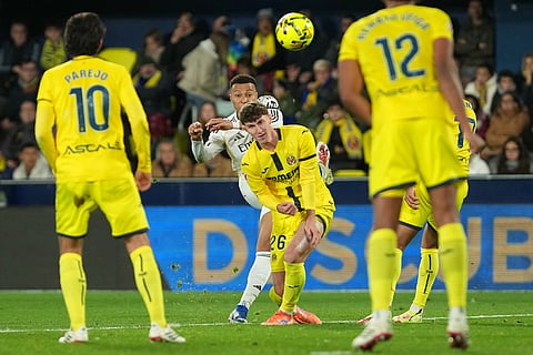 Real Madrid's Kylian Mbappe, center, takes a shot during a Spanish La Liga soccer match between Villarreal and Real Madrid in Villarreal, Spain.