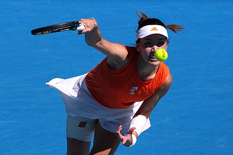 Wang Xinyu of China serves to Amanda Anisimova of the U.S. during their fourth round match at the Australian Open tennis championship in Melbourne, Australia.