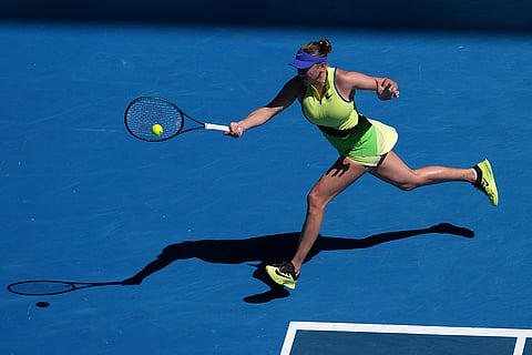 Amanda Anisimova of the U.S. plays a forehand return to Wang Xinyu of China during their fourth round match at the Australian Open tennis championship in Melbourne, Australia.