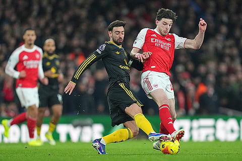 Arsenal's Leandro Trossard, right, is challenged by Manchester United's Diogo Dalot during the English Premier League soccer match between Arsenal and Manchester United in London.