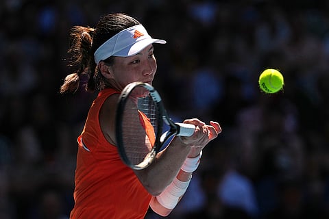 Wang Xinyu of China plays a forehand return to Amanda Anisimova of the U.S. during their fourth round match at the Australian Open tennis championship in Melbourne, Australia.