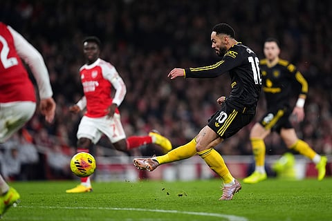 Manchester United's Matheus Cunha scores their side's third goal of the game during the English Premier League soccer match between Arsenal and Manchester United in London.