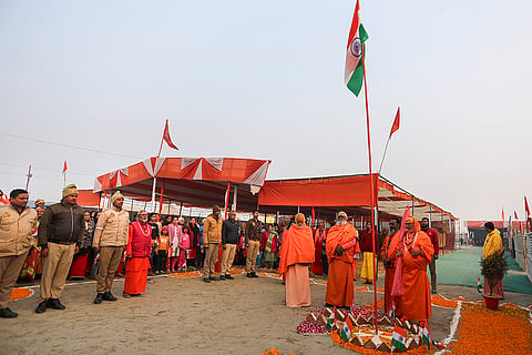 'Sadhus' and security personnel during the 77th Republic Day celebrations at the Sangam, in Prayagraj.