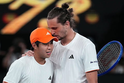Alexander Zverev, right, of Germany is congratulated by Learner Tien, left, of the U.S. following their quarterfinal match at the Australian Open tennis championship in Melbourne, Australia.
