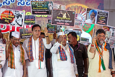 Karnataka Chief Minister Siddaramaiah, second right, with Deputy CM DK Shivakumar, right, and Congress MP Randeep Singh Surjewala, during the 'Raj Bhavan Chalo' protest march over the repeal of changes to MGNREGA, at Freedom Park in Bengaluru.