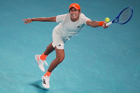 Learner Tien of the U.S. plays forehand return to Alexander Zverev of Germany during their quarterfinal match at the Australian Open tennis championship in Melbourne, Australia.