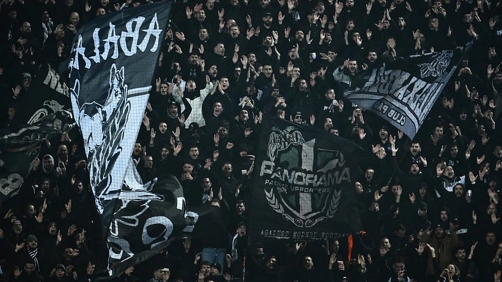 | Photo: AP/Giannis Papanikos. : PAOK's fans wave giant flags of their team during the Europa League match against Real Betis in Thessaloniki, Greece, on Thursday, January 22, 2026.