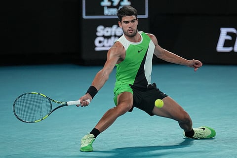 Carlos Alcaraz of Spain plays a forehand return to Alex de Minaur of Australia during their quarterfinal match at the Australian Open tennis championship in Melbourne, Australia.