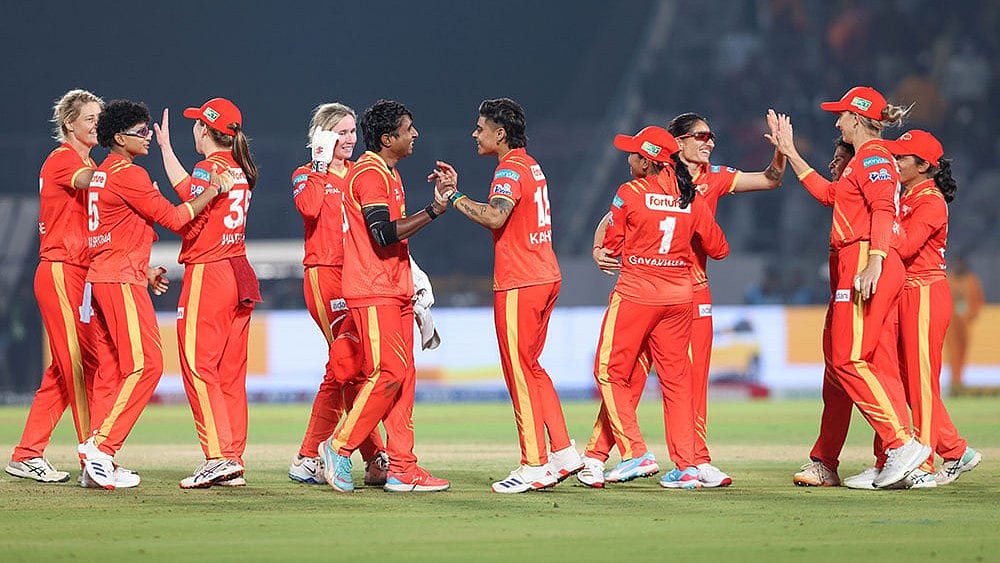 Photo: BCCI via PTI  : Gujarat Giants' players celebrate after winning the match against Delhi Capitals during the Women’s Premier League (WPL) 2026 T20 cricket match at the BCA Stadium, in Vadodara, Gujarat.