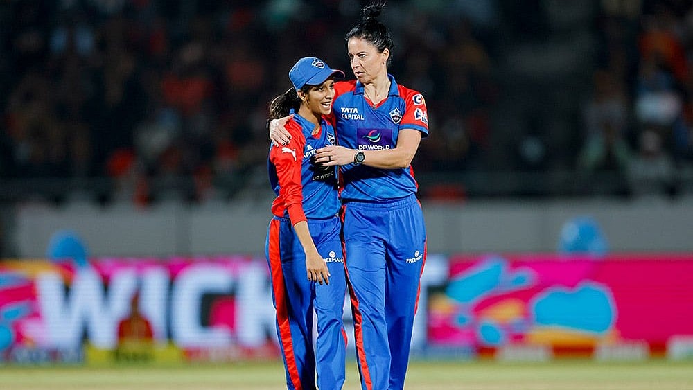 | Photo: BCCI via PTI  : Delhi Capitals' Marizanne Kapp celebrates with captain Jemimah Rodrigues after taking the wicket of Royal Challengers Bengaluru's Georgia Voll.