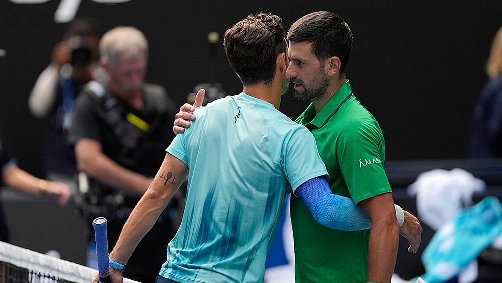| Photo: AP/Asanka Brendon Ratnayake : Lorenzo Musetti, left, of Italy embraces Novak Djokovic of Serbia after retiring from their quarterfinal match at the Australian Open tennis championship in Melbourne, Australia.